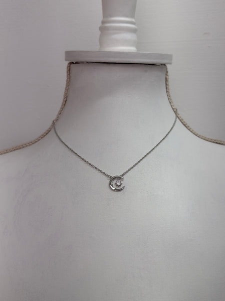 silver necklace with crescent moon an star pendant dainty celestial design.