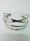 A silver bracelet with a minimalist multi strand cross over design.