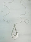 A silver necklace with a teardrop-shaped pendant on a light background.