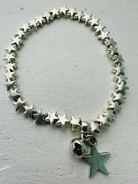 A silver-colored bracelet made up of connected star shapes with a larger star pendant.