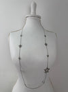 Star-shaped necklace on a mannequin against a white background