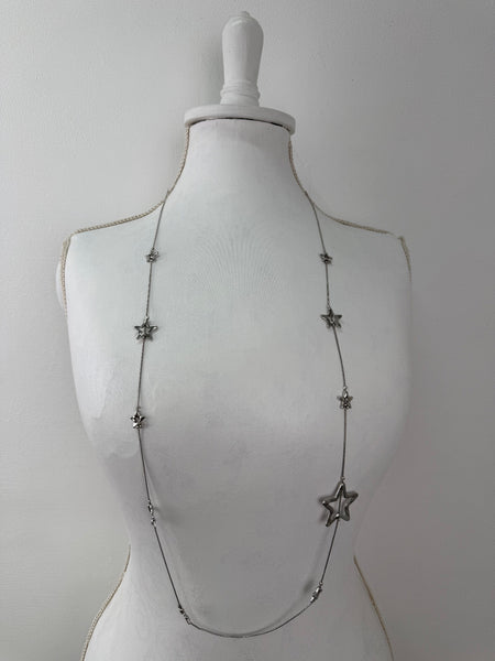 Star-shaped necklace on a mannequin against a white background