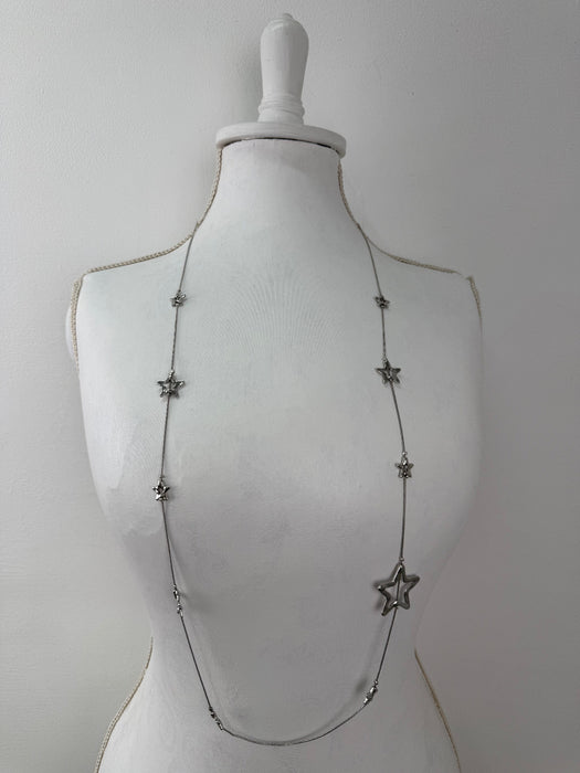 Star-shaped necklace on a mannequin against a white background