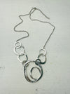front of silver abstract circle link necklace