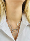  silver textured circle link necklace with abstract overlapping rings displayed on a model