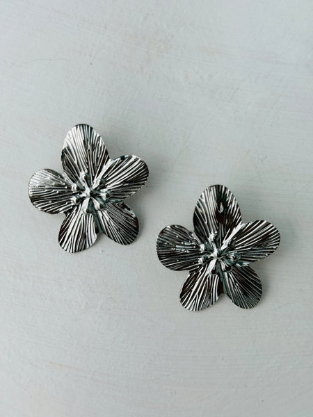 front view of silver-tone floral earrings 