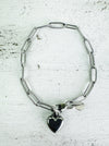 Silver-tone link chain bracelet with polished heart charm, displayed on a white background.