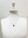 Necklace on a mannequin bust against a white background
