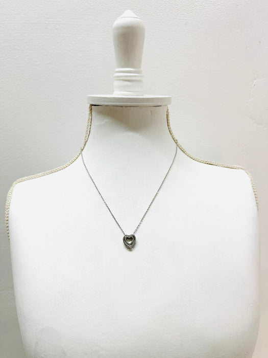 Necklace on a mannequin bust against a white background
