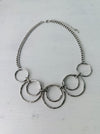 close-up of modern silver tone necklace with layered open circles