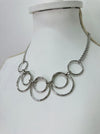 side angle of modern silver tone necklace with layered open circles