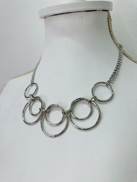 side angle of modern silver tone necklace with layered open circles