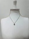 Necklace with a pendant on a mannequin bust against a plain background