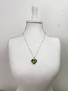 Heart-shaped pendant on a necklace displayed on a mannequin bust against a white background