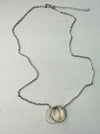Silver chain necklace with three interlinked mixed metal rings in gold, rose gold, and silver colours