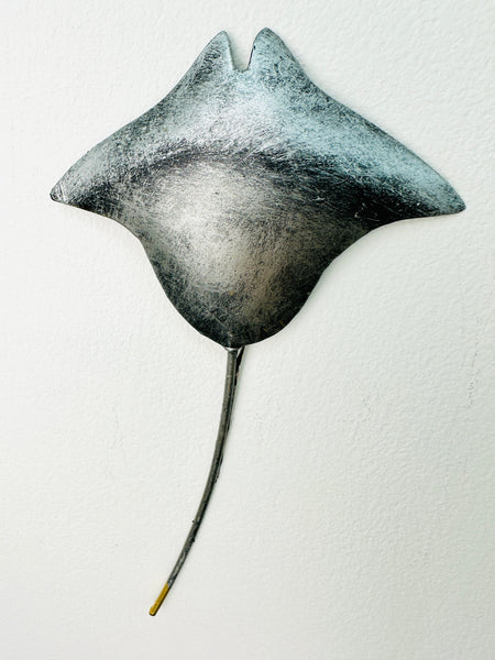 Close-up of hand-painted metallic manta ray showing silver shading and detailing.