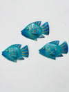 Three turquoise metal reef fish wall decorations displayed together