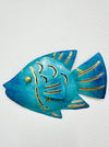 A wall art decoration in the shape of a turquoise reef fish with gold detailing, crafted from sheet metal.