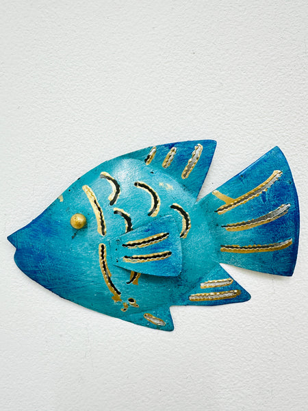 A wall art decoration in the shape of a turquoise reef fish with gold detailing, crafted from sheet metal.
