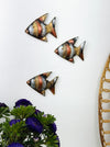 Copper zebra fish wall art displayed in a decorative grouping on a wall
