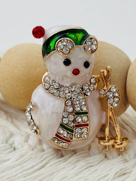 close-up of christmas snowman brooch with crystal effect details
