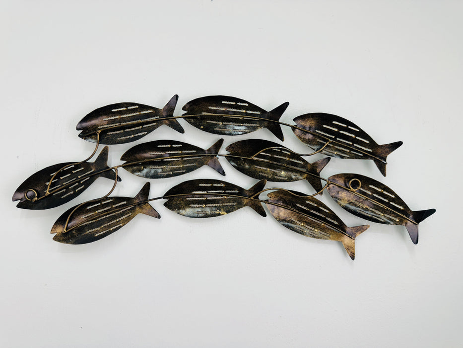 Back of small aqua striped metal fish showing back and hidden eyelets.