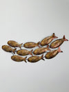 Small copper mottled metal fish shoal wall art with 10 fish on a white background