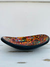 Side view of small handmade mosaic oval bowl in Calypso colours with red, orange and gold glass mosaic tiles.