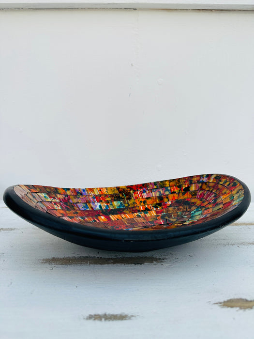 Side view of small handmade mosaic oval bowl in Calypso colours with red, orange and gold glass mosaic tiles.