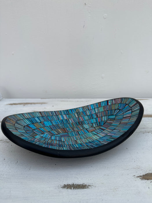 Side view of handmade small oval mosaic bowl in Miami design with light blue and aqua glass mosaic pieces.