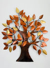 Metal tree wall art with autumn leaves on a white background