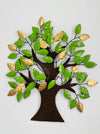 Decorative wall art of a tree with green and gold leaves on a white background