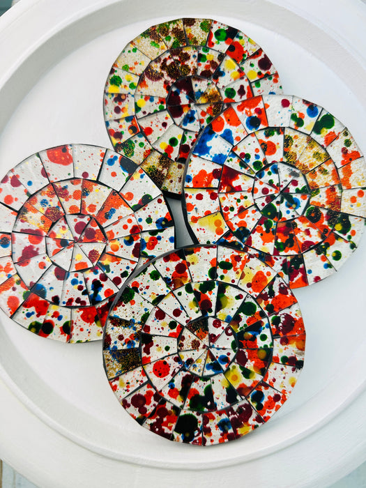 Group of Spectrum mosaic coasters displaying their vibrant and varied hand-painted glass patterns on a white background.