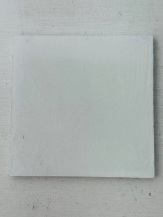 Back of the Cyan Brick mosaic coaster showing the smooth white MDF base on a light background.