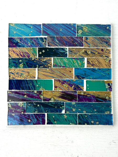 Square Cyan Brick mosaic coaster with hand-painted glass rectangles in blue and green tones arranged on an MDF base, photographed from above on a light surface.