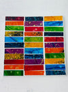 Square Rainbow Brick mosaic coaster with colourful rectangular hand-painted glass pieces arranged on an MDF base, photographed from above on a light surface.