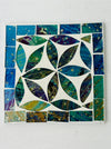 Square Cyan Peacock mosaic coaster with hand-painted glass pieces in blue and green tones arranged in a geometric pattern on an MDF base, photographed from above.