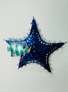 A blue metal starfish wall decor, hand painted with intricate patterns.