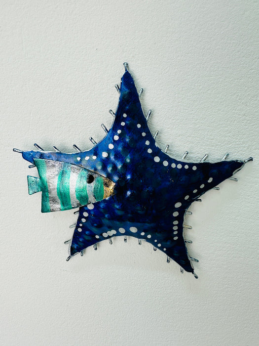 A blue metal starfish wall decor, hand painted with intricate patterns.