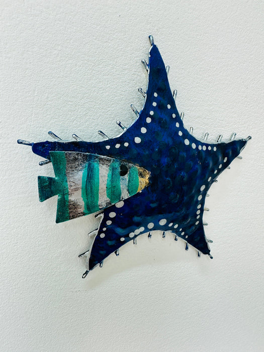 Side-angle view of blue metal starfish showing painted detail