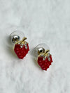 Strawberry-shaped earrings with red gemstones on a white background