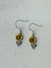 Sunflower dangle earrings with gold-tone petals and silver-tone leaves.