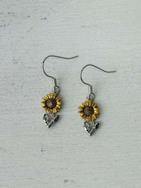 Sunflower dangle earrings with gold-tone petals and silver-tone leaves.