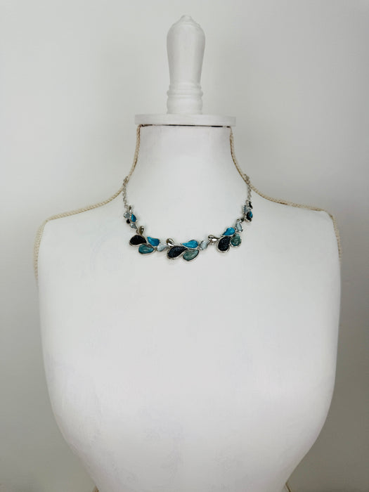 Teardrop enamel necklace in turquoise, grey, gunmetal and silver tones, displayed on a mannequin.
