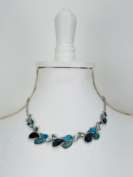 Teardrop enamel necklace in turquoise, grey, gunmetal and silver tones, displayed on a mannequin.