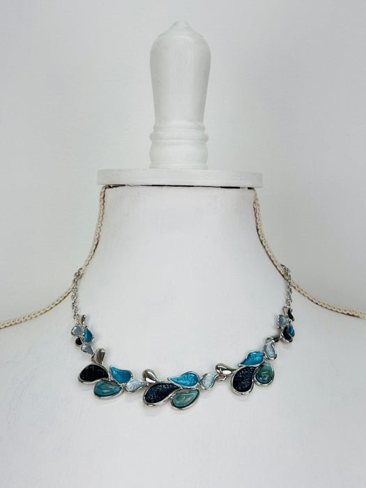 Teardrop enamel necklace in turquoise, grey, gunmetal and silver tones, displayed on a mannequin.