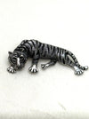 Silver tiger brooch on a white background