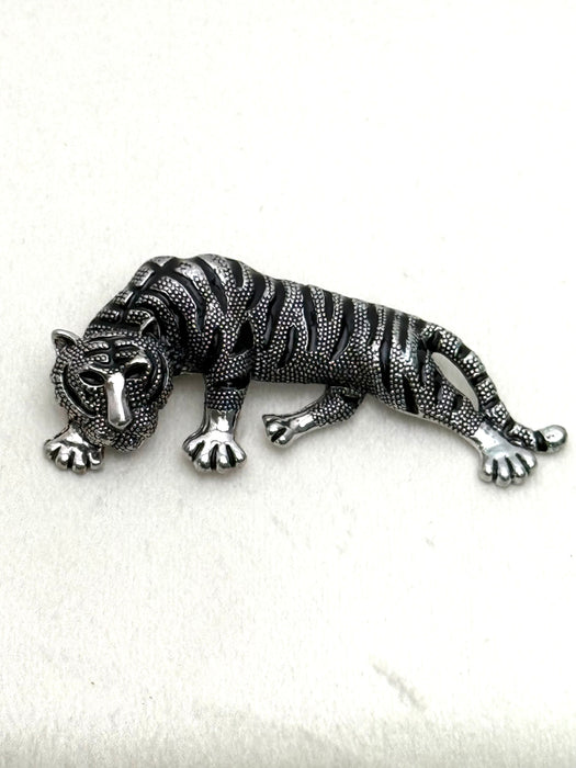 Silver tiger brooch on a white background