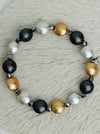 Tri-tone metallic beaded elastic bracelet in gold, silver and dark grey tones with grey spacer beads, displayed on a white background.