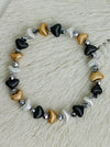 Tri-tone metallic beaded elastic bracelet in gold, silver and dark grey tones with grey spacer beads.